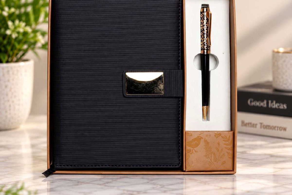 Black corporate diary with a gold-trim pen presented in a premium gift box